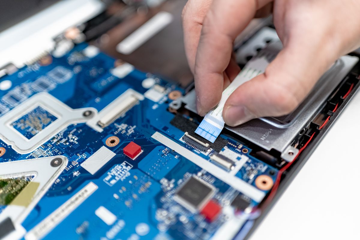 Engineer repairing a laptop